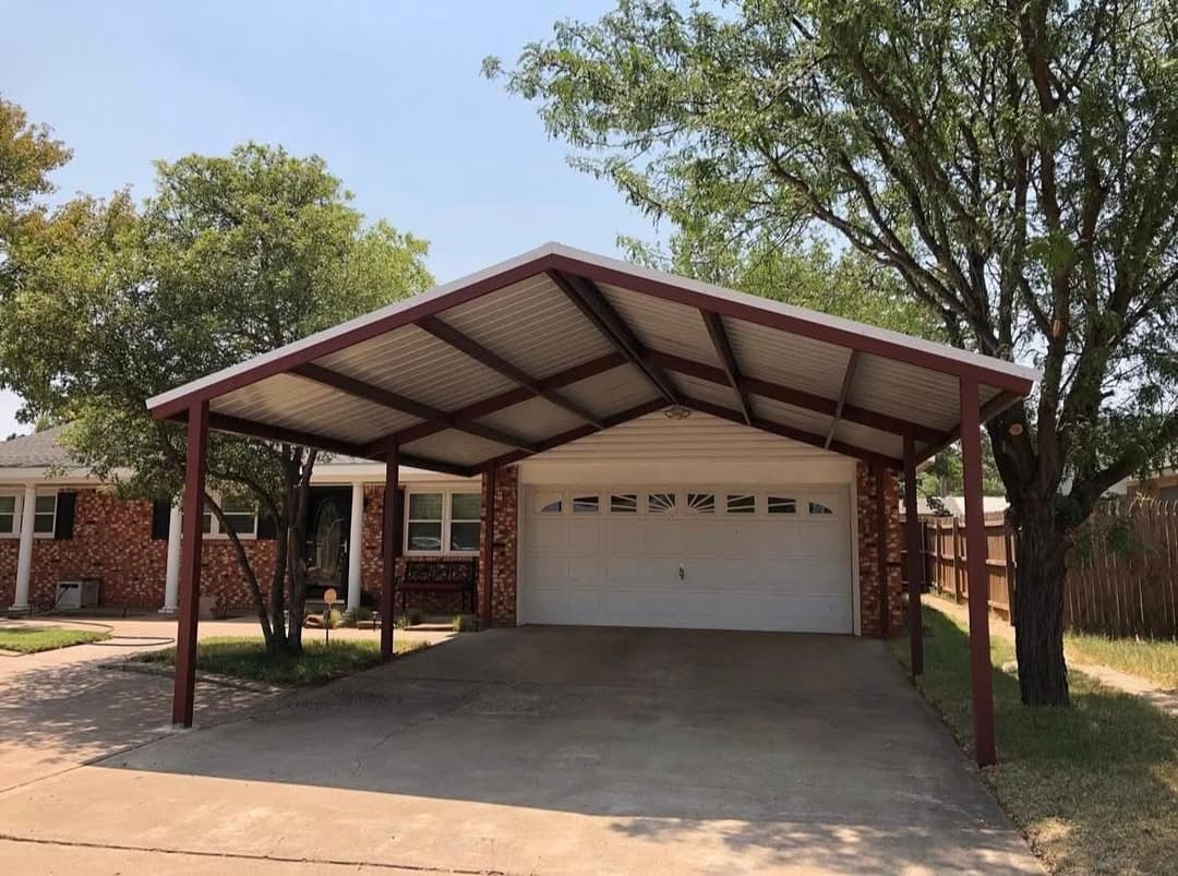 House exterior with carport, brick facade, and driveway shaded by trees.